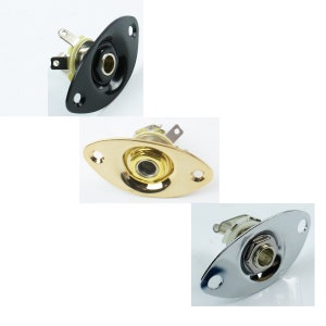 May include: Three guitar output jacks in black, gold, and chrome finishes. Each jack has a round opening and two mounting holes. The jacks are oval shaped and have a beveled edge.