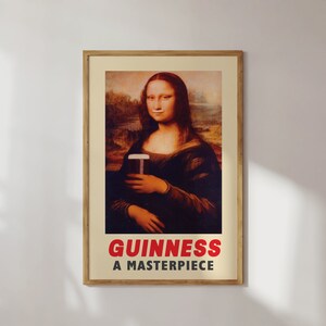 May include: A vintage-style poster featuring a painting of the Mona Lisa holding a glass of Guinness. The text "GUINNESS A MASTERPIECE" is printed in red at the bottom of the poster.