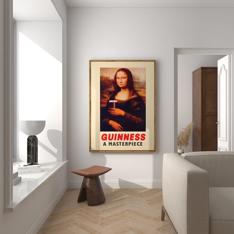 May include: A framed poster with a painting of the Mona Lisa holding a glass of Guinness. The poster has the text "GUINNESS A MASTERPIECE" at the bottom.