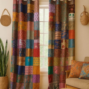 May include: Patchwork curtains in a variety of colors, including red, blue, yellow, and purple, hang in front of a window. The curtains are made of squares of fabric with different patterns and textures. A woven basket and a plant are visible on the left.
