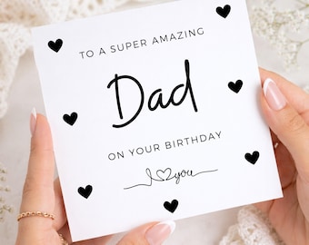 May include: A square white greeting card featuring black text that reads TO A SUPER AMAZING Dad ON YOUR BIRTHDAY with a handwritten style I love you graphic below. The card is decorated with six small black hearts arranged around the text.
