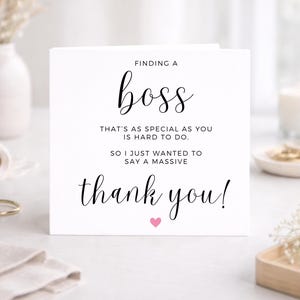 May include: A white square greeting card with black text that reads: FINDING A boss THAT'S AS SPECIAL AS YOU IS HARD TO DO. SO I JUST WANTED TO SAY A MASSIVE thank you! A small pink heart is printed below the text on the front of the card.
