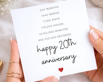 May include: A square white greeting card featuring black text that reads 240 MONTHS, 1042 WEEKS, 7,300 DAYS, 175,200 HOURS, 10,512,000 MINUTES, 630,720,000 SECONDS, and happy 20th anniversary, with a small red heart icon at the bottom center.