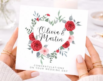 Biglietto di auguri per il giorno del matrimonio con i nomi degli sposi, biglietto con cuore floreale e rose rosse, biglietto di congratulazioni per la sposa, lo sposo e i novelli sposi.