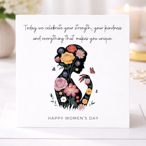 Op de afbeelding: Witte wenskaart met een zwart silhouet van een vrouw, gevuld met kleurrijke bloemen en vlinders. De kaarttekst luidt: "Vandaag vieren we je kracht, je vriendelijkheid en alles wat je uniek maakt." en "HAPPY WOMEN'S DAY."