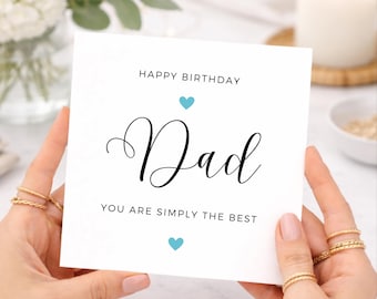 May include: A square white greeting card with black text that reads HAPPY BIRTHDAY, Dad, and YOU ARE SIMPLY THE BEST. The card features two small light blue heart icons, one positioned above the word Dad and one positioned below the text.