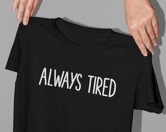 May include: Black t-shirt with white text that reads "ALWAYS TIRED".