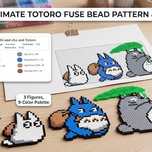 May include: A fuse bead kit featuring the text ULTIMATE TOTORO FUSE BEAD PATTERN & KIT. Includes a printed pattern sheet with a 9-color palette, three assembled character figures, a clear pegboard, tweezers, and a container of assorted beads.