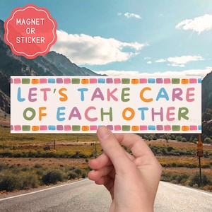 May include: A rectangular sticker or magnet featuring the text LET'S TAKE CARE OF EACH OTHER in multi-colored letters. The design is bordered by a row of small, colorful, watercolor-style squares along the top and bottom edges.