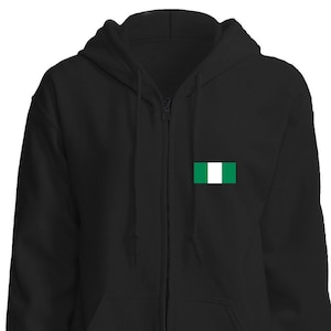 May include: A black zippered hoodie with a small green and white flag on the left chest. The flag is the flag of Nigeria.