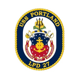 May include: A blue and gold circular emblem with the text "USS PORTLAND LPD 27" and a shield with an anchor, trident, and swords. The text "First Responders and Determined Brave" is written around the shield.