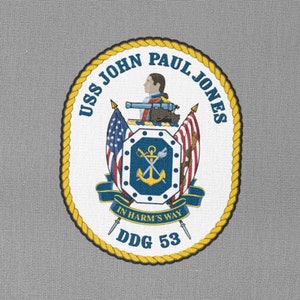 May include: A circular patch with a yellow rope border and a white background. The patch features a navy blue anchor with crossed swords, a shield with a cannon and a figure holding a sword, and the text "USS JOHN PAUL JONES DDG 53" in a navy blue font. The text "IN HARM'S WAY" is also present in a navy blue font.