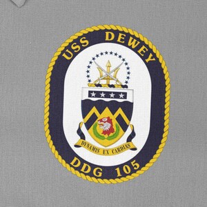 May include: A navy blue and gold embroidered patch with the text "USS DEWEY DDG 105" and a crest featuring a trident, stars, and a lion.