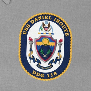May include: A navy blue and gold circular patch with the text "USS DANIEL INOUYE DDG 118" and a crest featuring a shield with a sun, palm trees, and crossed swords.