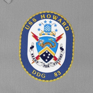 May include: A blue and gold embroidered patch with the text "USS HOWARD DDG 83" and a crest featuring a dragon, lightning bolts, and stars.