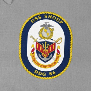 Könnte beinhalten: Ein blauer und goldener runder Aufnäher mit dem Text "USS SHOUP DDG 86" und einem Wappen mit einem Dreizack, einem Anker und einem Adler.