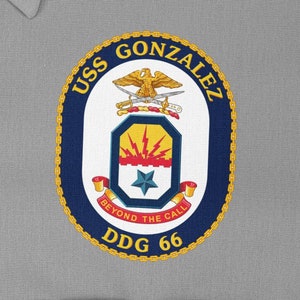May include: A navy blue and gold embroidered patch with the text "USS GONZALEZ DDG 66" and the words "Beyond the Call" in a banner below a crest with a star and lightning bolts.