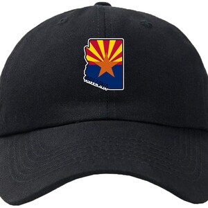 May include: A black baseball cap with an embroidered Arizona state outline and flag design. The flag features red and yellow rays, a blue background, and a white star.