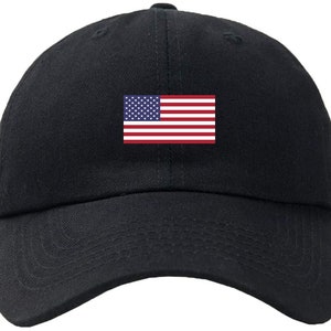 May include: A black baseball cap with a small American flag embroidered on the front.