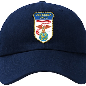 May include: A navy blue baseball cap with a patch featuring the text "USS ESSEX LHD 2" and a crest with an eagle, a sword, and a globe.