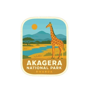 May include: A rectangular sticker depicting a giraffe in a savanna scene. The giraffe is orange with brown patches. The sticker includes the text "AKAGERA NATIONAL PARK RWANDA" in white and brown. The background shows mountains and a river.