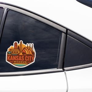 A sticker on the side of a car window that says "KANSAS CITY MISSOURI".