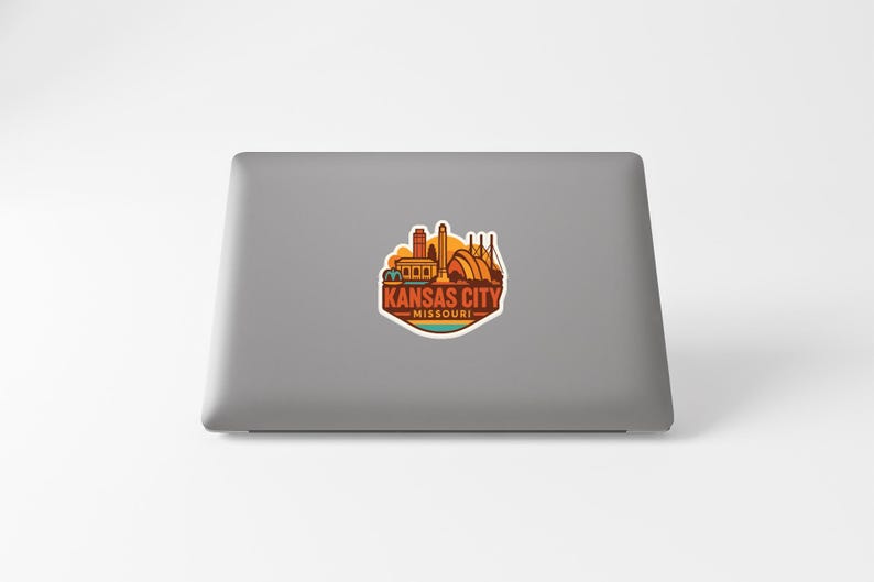 a sticker with the text "KANSAS CITY MISSOURI" on a grey laptop.