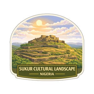May include: A sticker showing the Sukur Cultural Landscape in Nigeria. The image features a hilltop settlement with stone buildings, surrounded by green vegetation and hills under a sunny sky. The text "SUKUR CULTURAL LANDSCAPE - NIGERIA" is displayed.