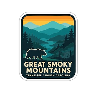 A sticker or logo featuring a bear silhouette against a mountain landscape with a sunset in the background.