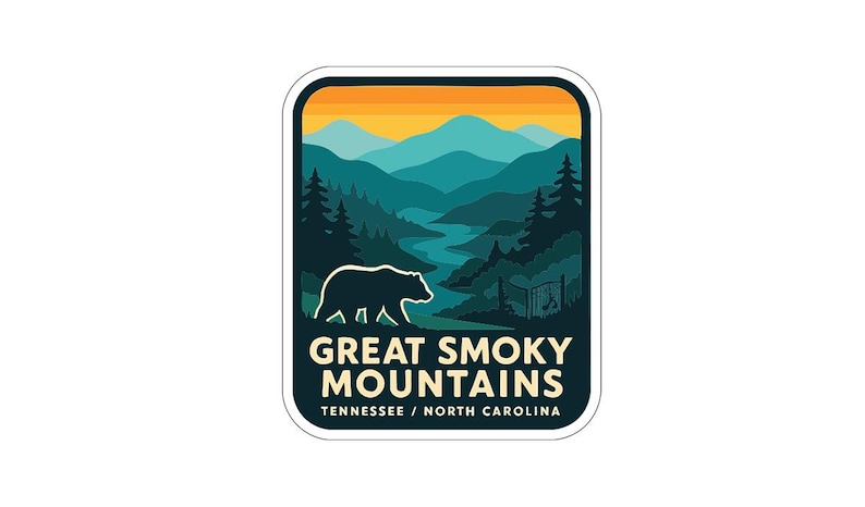 A sticker or logo featuring a bear silhouette against a mountain landscape with a sunset in the background.