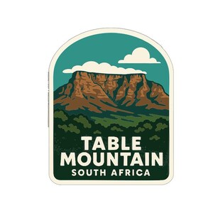 May include: A sticker featuring Table Mountain in South Africa. The design includes a brown mountain, green trees, and a teal sky with a white cloud. The words "TABLE MOUNTAIN SOUTH AFRICA" are printed in white.