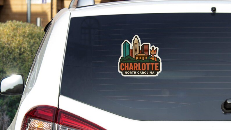 A sticker on the rear window of a car that says "Charlotte North Carolina".