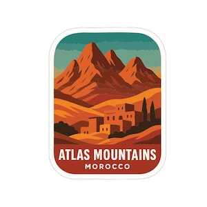 Puede incluir: Una pegatina con un paisaje de las montañas del Atlas en Marruecos. El diseño incluye montañas naranjas, un pueblo y el texto "ATLAS MOUNTAINS MOROCCO" en un marco rectangular con esquinas redondeadas.