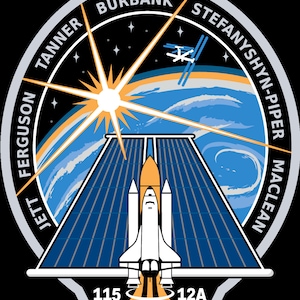 May include: A space shuttle patch with a white space shuttle against a blue and orange background. The patch features the names of the astronauts: Jett Ferguson, Tanner Burbank,  Stefany Shy-Piper, and Maclean. The numbers 115 and 12A are at the bottom of the patch.