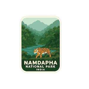 May include: A rectangular sticker depicting a tiger in a forest scene with a river. The sticker has a green border and the text "NAMDAPHA NATIONAL PARK INDIA" in white.