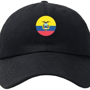 May include: A black baseball cap with an embroidered yellow, blue and red Ecuadorian flag on the front.