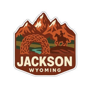 May include: A sticker featuring a mountain range with a cowboy on horseback and an archway over a river. The text "JACKSON WYOMING" is displayed in a bold font, with a brown and orange color scheme.