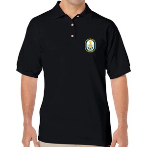 May include: Black polo shirt with a small embroidered patch on the left chest. The patch is navy blue with gold accents and features a crest with a crown and a ship.