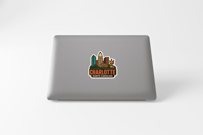 A sticker depicting the skyline of Charlotte, North Carolina, on the back of a laptop computer.