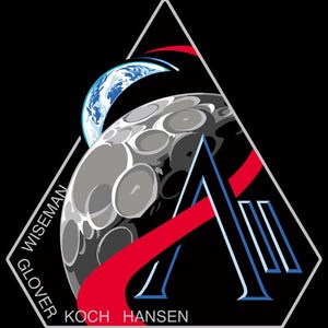 May include: A triangular patch with a black background features a stylized moon, Earth, and a large letter "A". Red and blue accents highlight the design. The names "WISEMAN", "GLOVER", "KOCH", and "HANSEN" are printed around the edges.