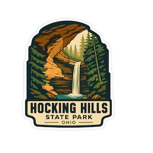 May include: A die-cut sticker featuring a graphic illustration of a waterfall cascading into a pool within a rocky cave, surrounded by dark green pine trees. The text HOCKING HILLS STATE PARK OHIO is printed in dark blue on a cream-colored base.