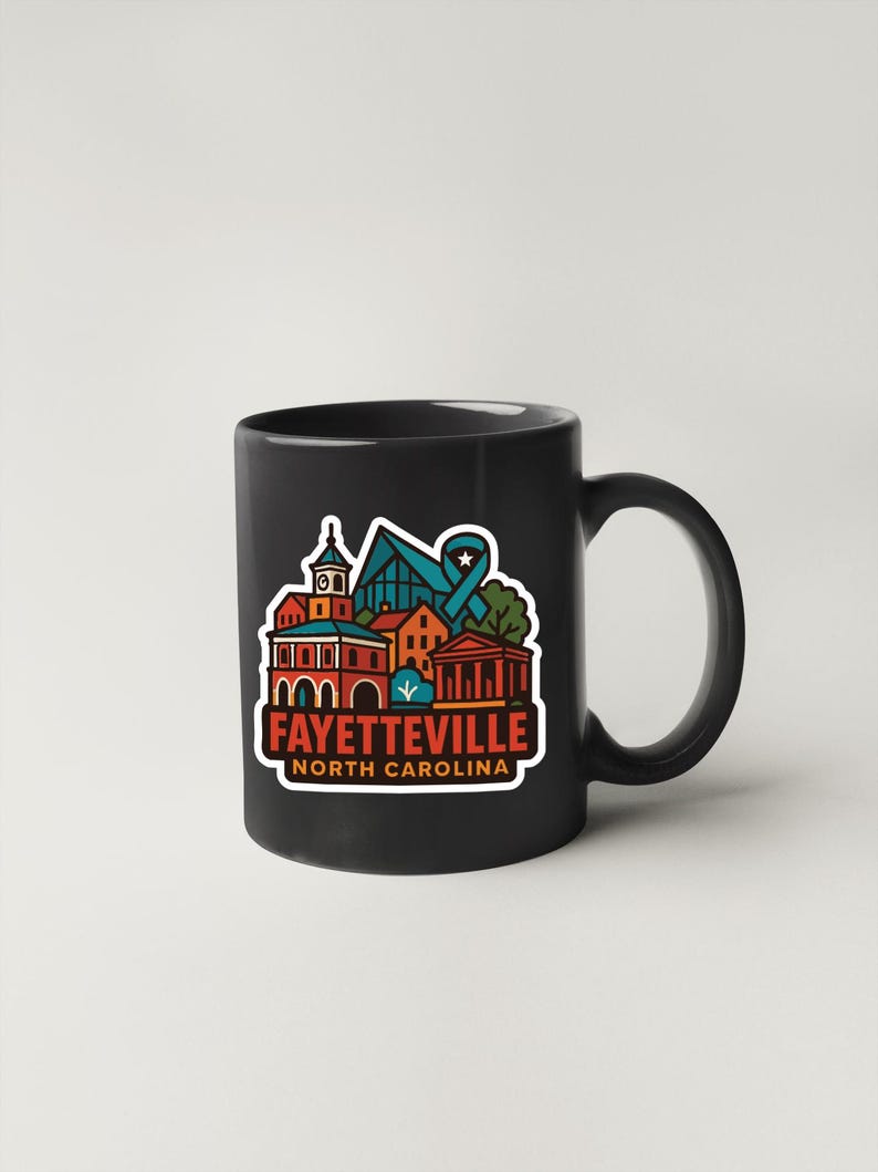 A black coffee mug with a colorful graphic design depicting the town of Fayetteville, North Carolina.