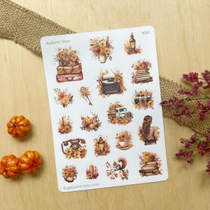 May include: A sheet of 20 autumn-themed stickers featuring images of flowers, pumpkins, a typewriter, a vintage truck, a lantern, a teapot, a squirrel, a phone, and books. The stickers are on a white background and have a handwritten title "Autumn Time" and the number "#041".