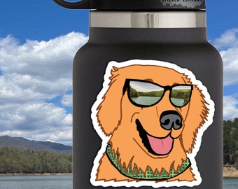 May include: A black water bottle with a sticker featuring a cartoon golden retriever wearing sunglasses. The dog has a green and yellow patterned bandana. The sticker is 2.5 x 2.5 inches. The text "LIFE OUTSIDE STICKER COMPANY" is at the top.