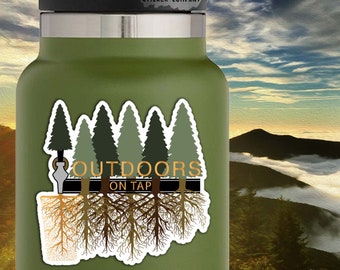 May include: A sticker with a green forest silhouette and the text "OUTDOORS ON TAP" in gold lettering. The trees have brown roots that extend down from the bottom of the sticker. The sticker is 2.5 inches by 2.5 inches.