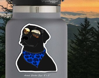 May include: A black Labrador Retriever wearing sunglasses and a blue paisley bandana. The sticker is 2 inches by 3 inches.