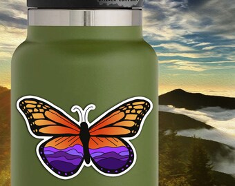 May include: A sticker of a butterfly with orange wings and a purple and blue mountain range design. The sticker is 3.5 inches by 2.25 inches. The sticker is on a green water bottle.