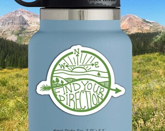 May include: Green and white compass sticker with the text "Find Your Direction" on a blue water bottle. The sticker is 3.25 inches by 2.5 inches.