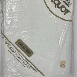 May include: A packaged white twin flat sheet. The label reads "PEQUOT" and "Twin Flat Sheet for 39 x 76 in. (99 x 193 cm.) mattress". The sheet is 66 x 96 in. (168 x 244 cm.) finished size and made of 65% Dacron polyester and 35% cotton.