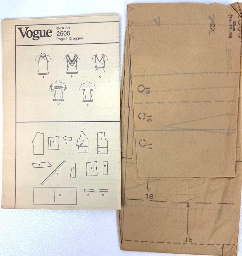 May include: A vintage Vogue sewing pattern, English 2505, featuring illustrations of tops and pattern pieces. The pattern includes a brown paper envelope with size markings.
